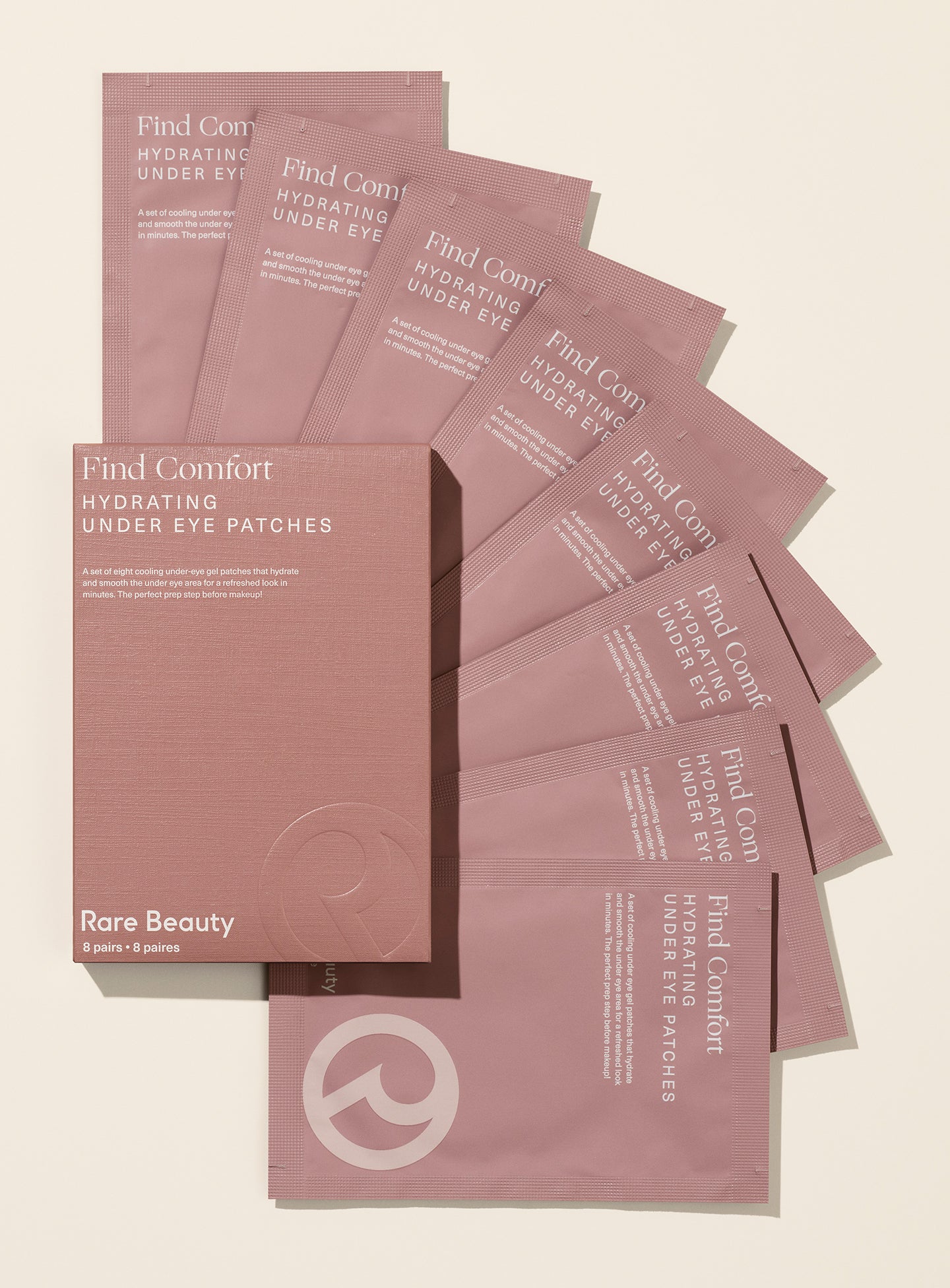 Rare Beauty's Find Comfort Hydrating Under Eye Patches spread out in a semi-circle, designed cool and smooth the under eye area for a refreshed look in minutes.